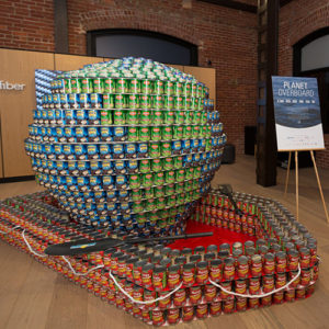 canned goods constructed to look like a planet in a boat